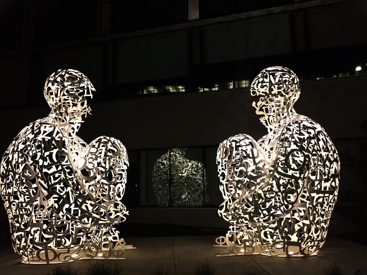 A sculpture of two men sitting